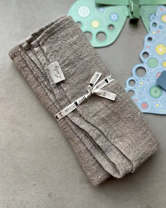 En linnebeige babyfilt.