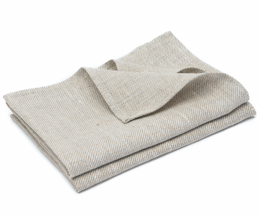 Två stycken kökshanddukar i naturell lin ligger ihopvikta i en hög.