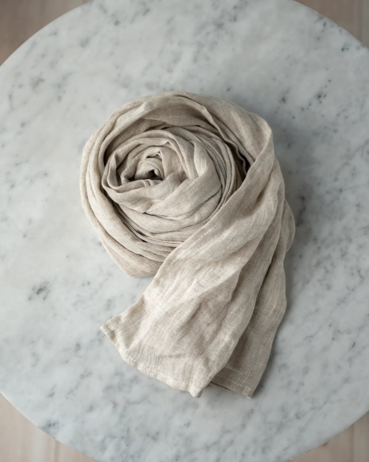 Handsydd linnescarf i beige.